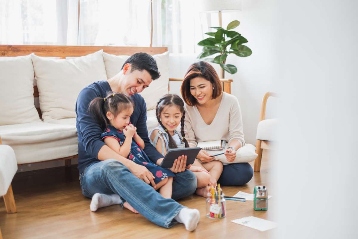 Happy family on sofa, Virginia Beach investment property management boosts tenant retention concept