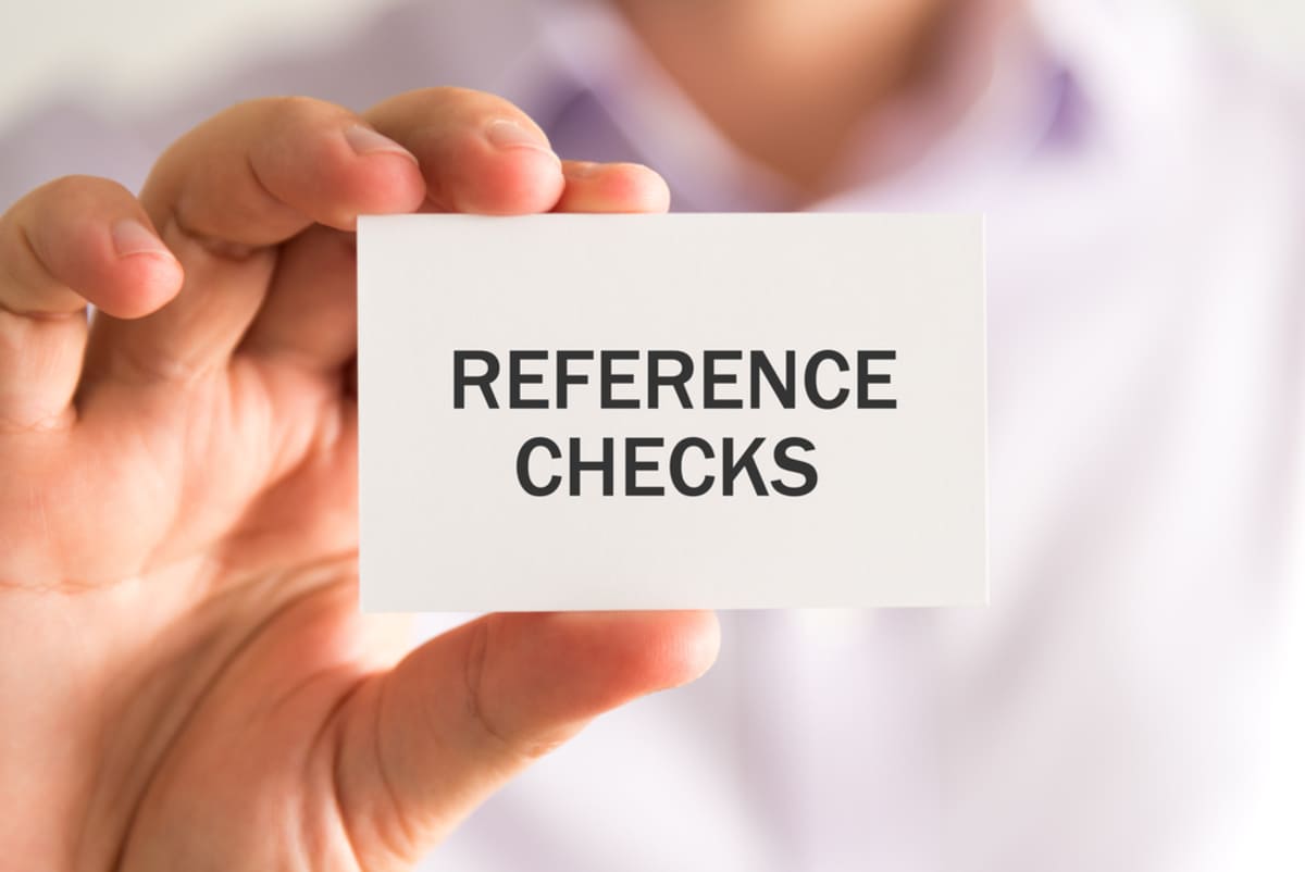 Someone holding a card that says reference checks